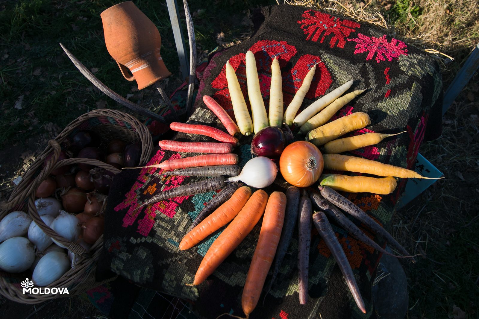 Moldovan vegetables laid out on a traditional woven carpet